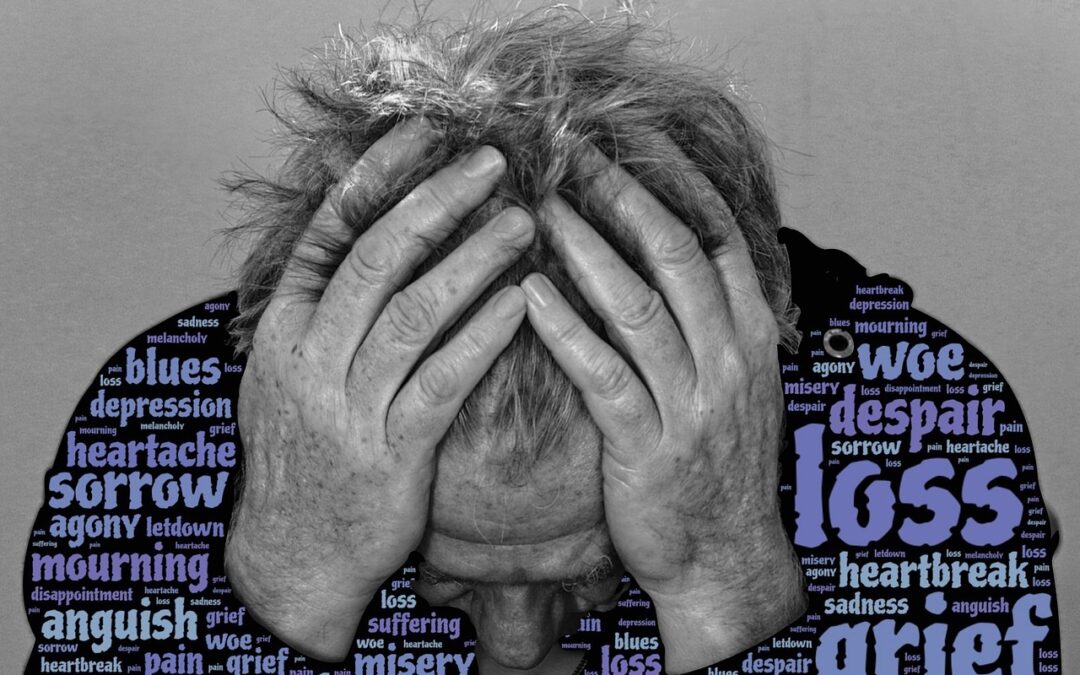 Man holding his head in his hands surrounded by words of gried and loss